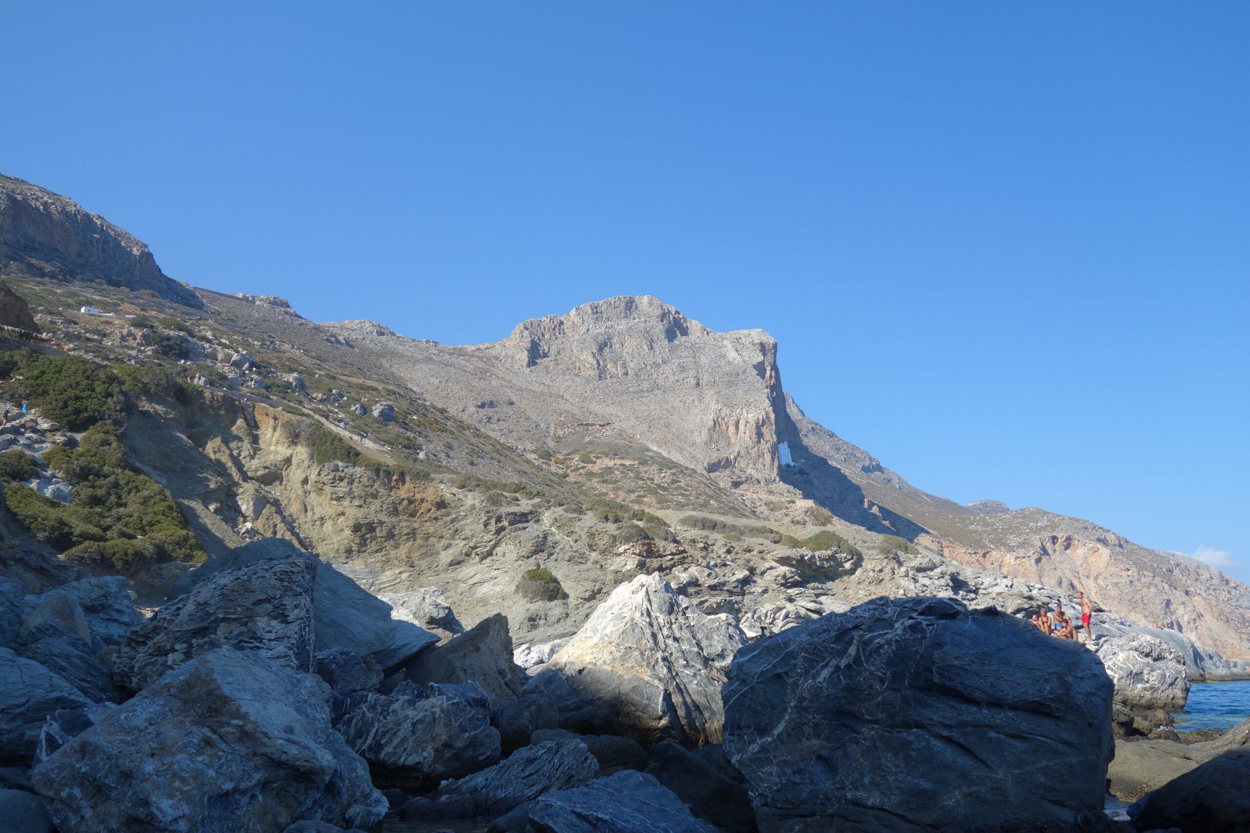 Stone steps winding up a rocky cliff toward the Hozoviotissa monastery