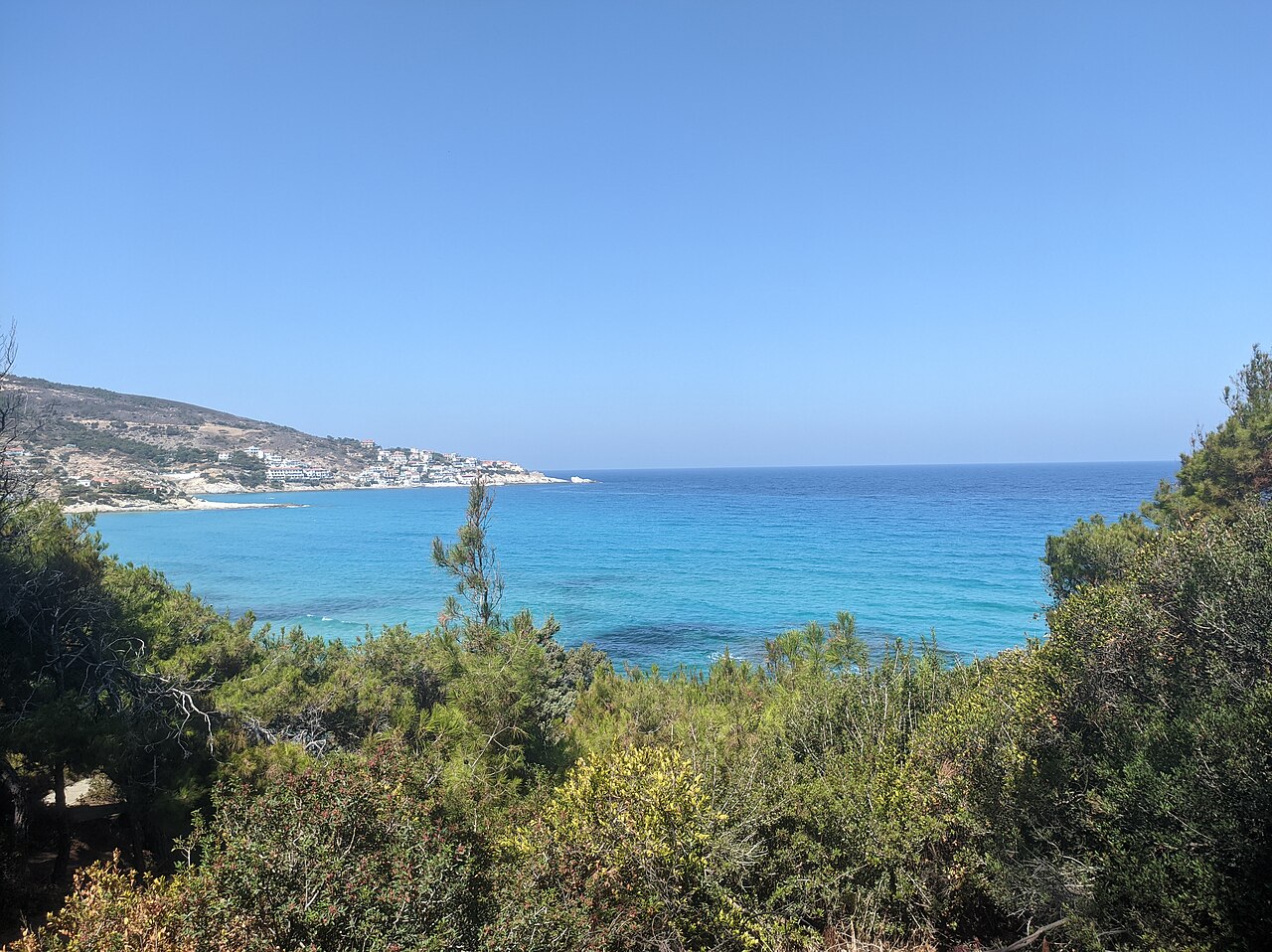Messakti Beach on Ikaria — a long sandy beach with waves, popular with surfers