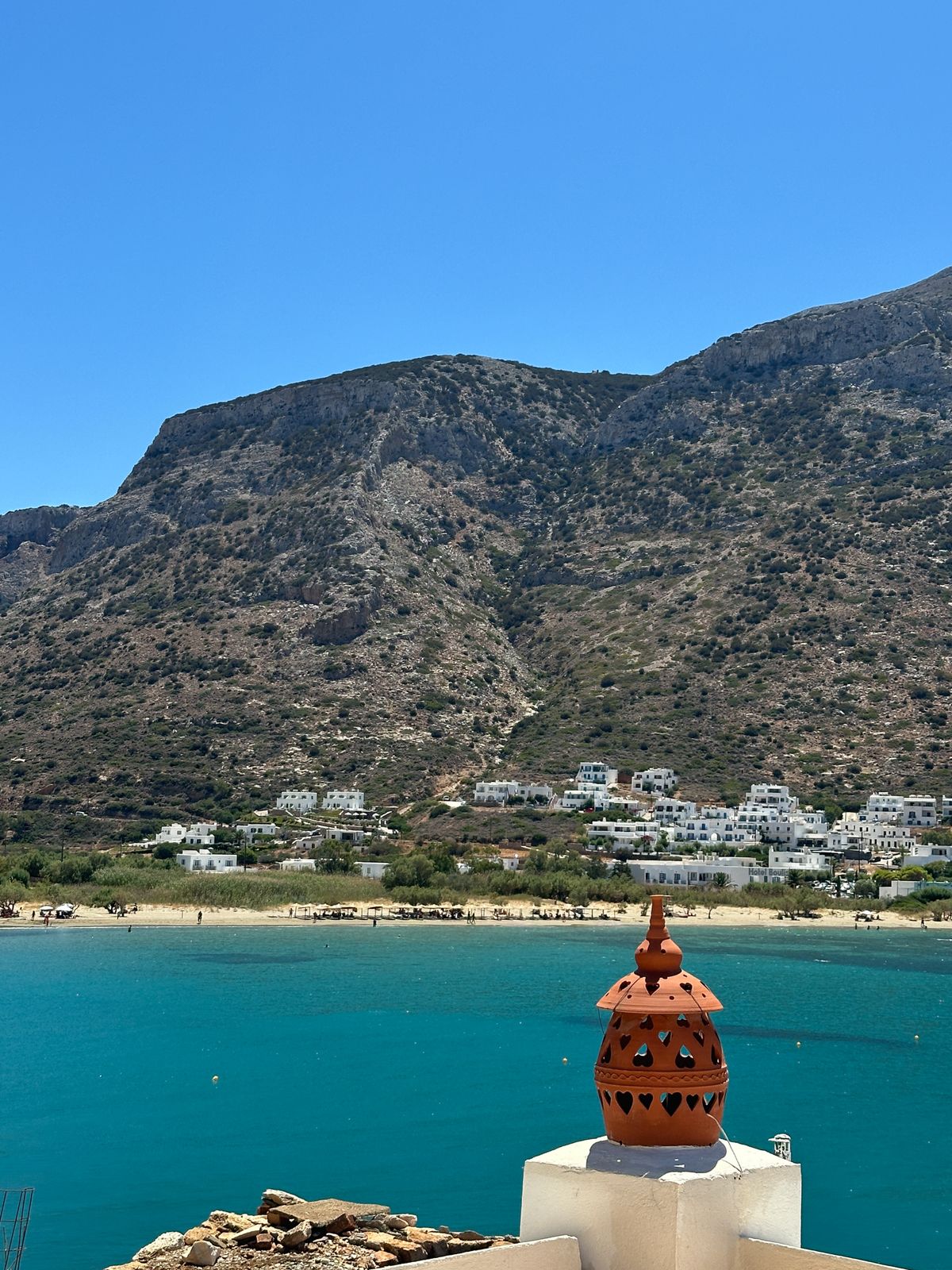 Scenic view of Sifnos island coastline with turquoise waters and Greek architecture, perfect for hiking