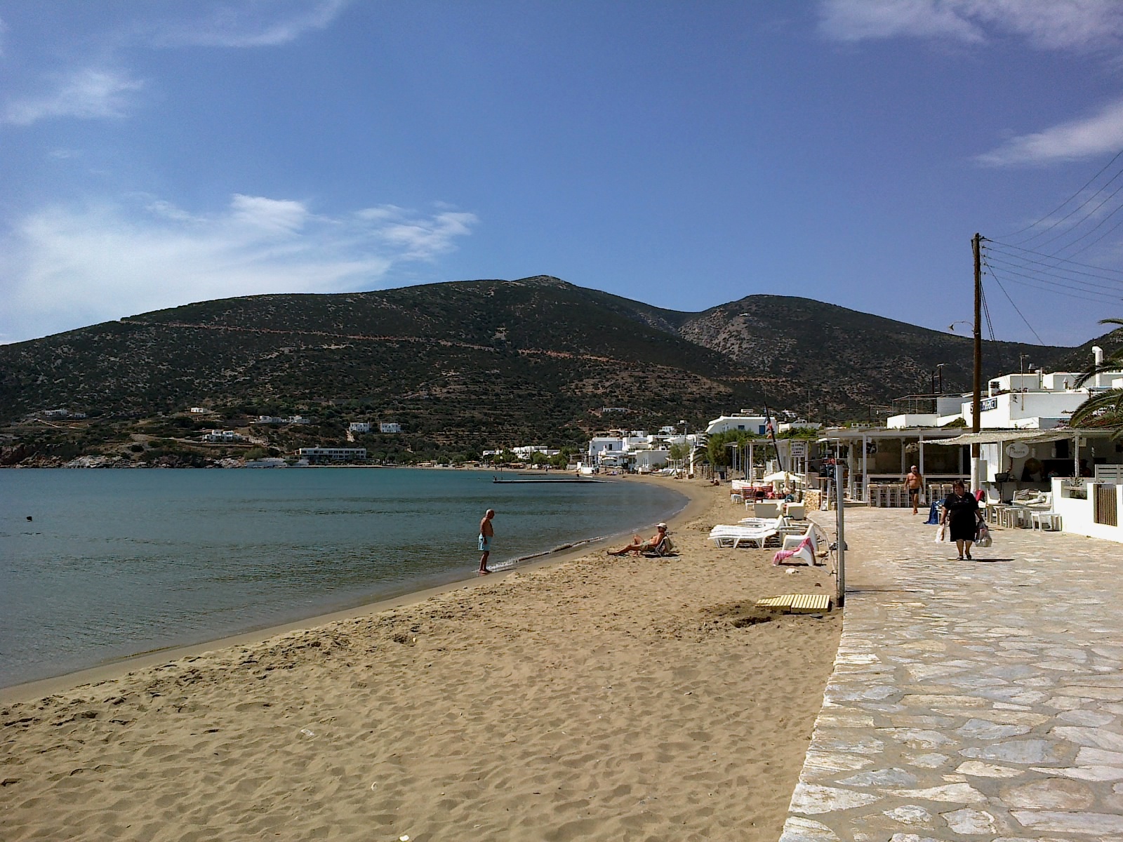 Platis Gialos beach, Sifnos, with turquoise water, sandy shore, and beachside tavernas