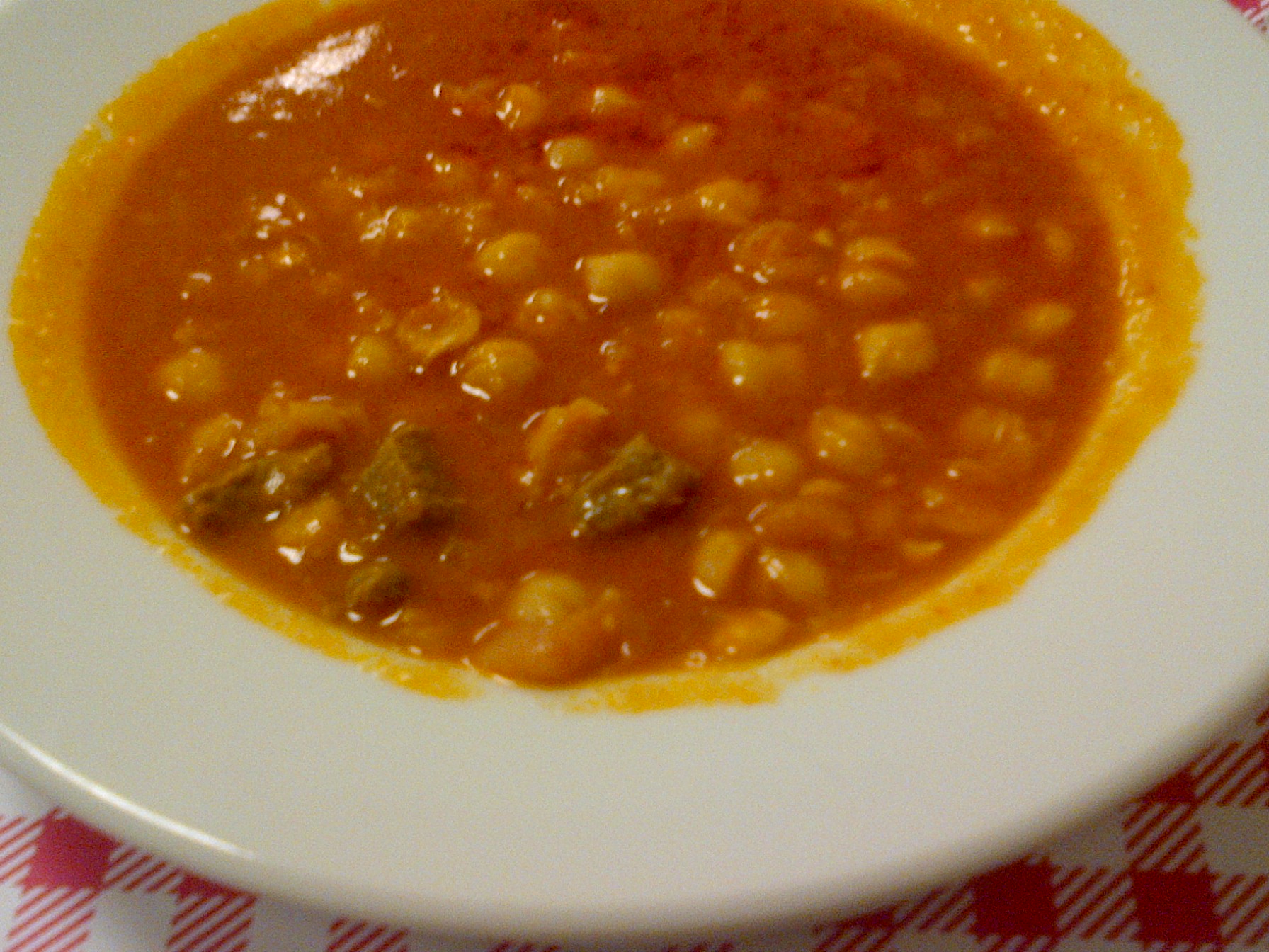 Traditional chickpea stew in a bowl with broth and herbs
