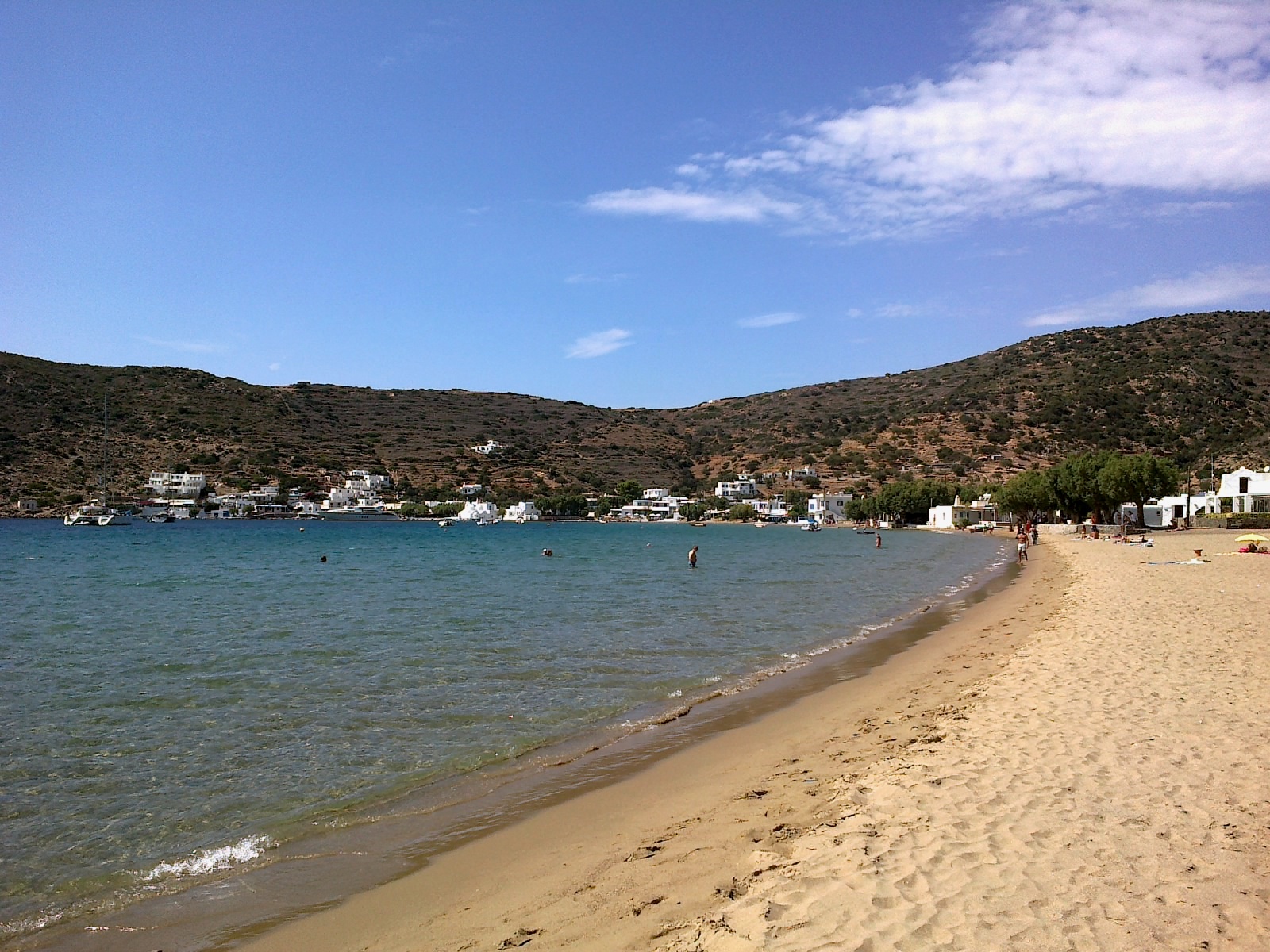 Vathi beach, Sifnos — a sheltered bay with calm turquoise water surrounded by hills