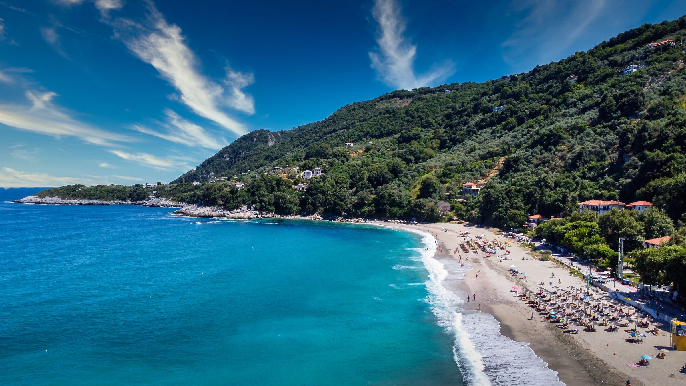 Aerial view of Agios Ioannis beach on the eastern coast of Pelion with turquoise water and green mountains