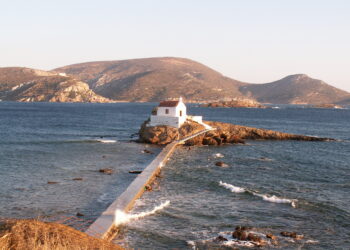The tiny chapel of Agios Isidoros built on a rocky reef in the sea on Leros island Greece