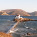 The tiny chapel of Agios Isidoros built on a rocky reef in the sea on Leros island Greece