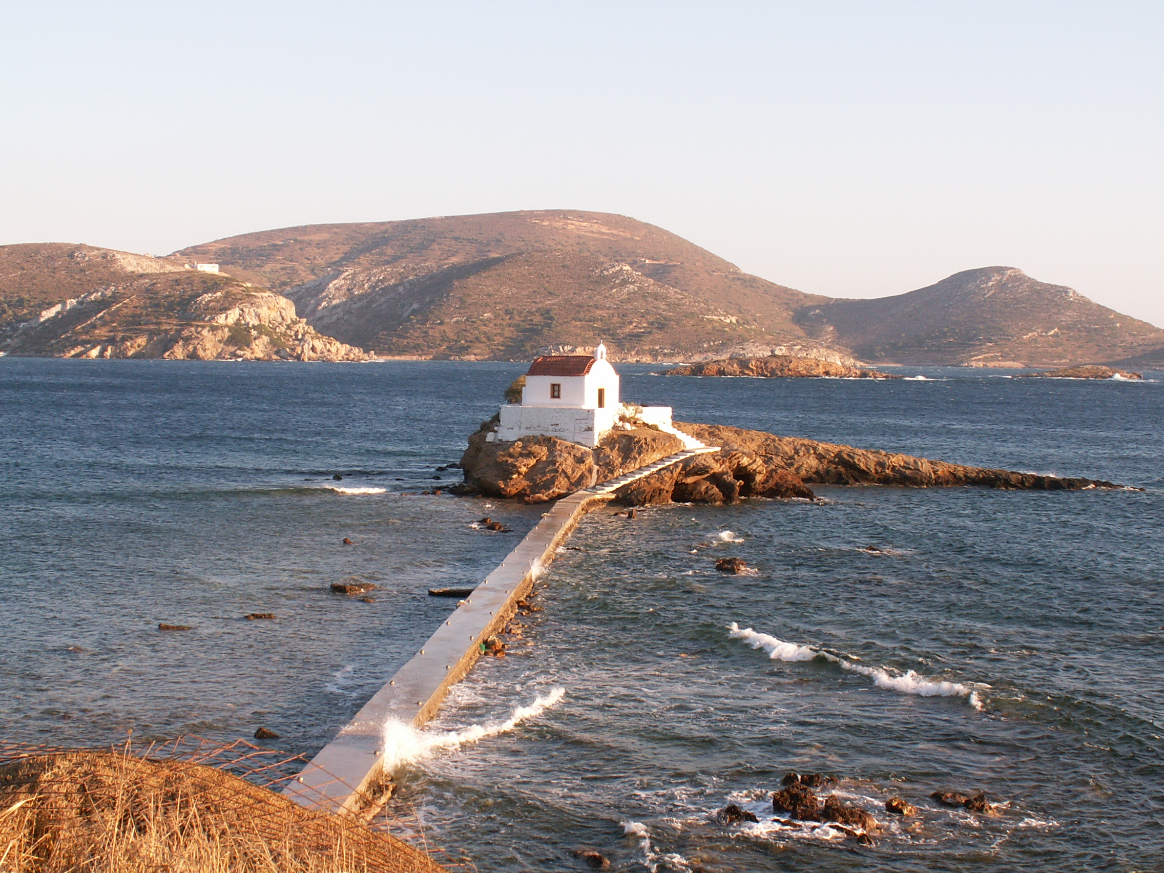 The tiny chapel of Agios Isidoros built on a rocky reef in the sea on Leros island Greece