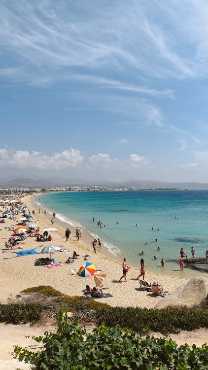 Sunbathers and turquoise waters at Agios Prokopios Beach on the western coast of Naxos