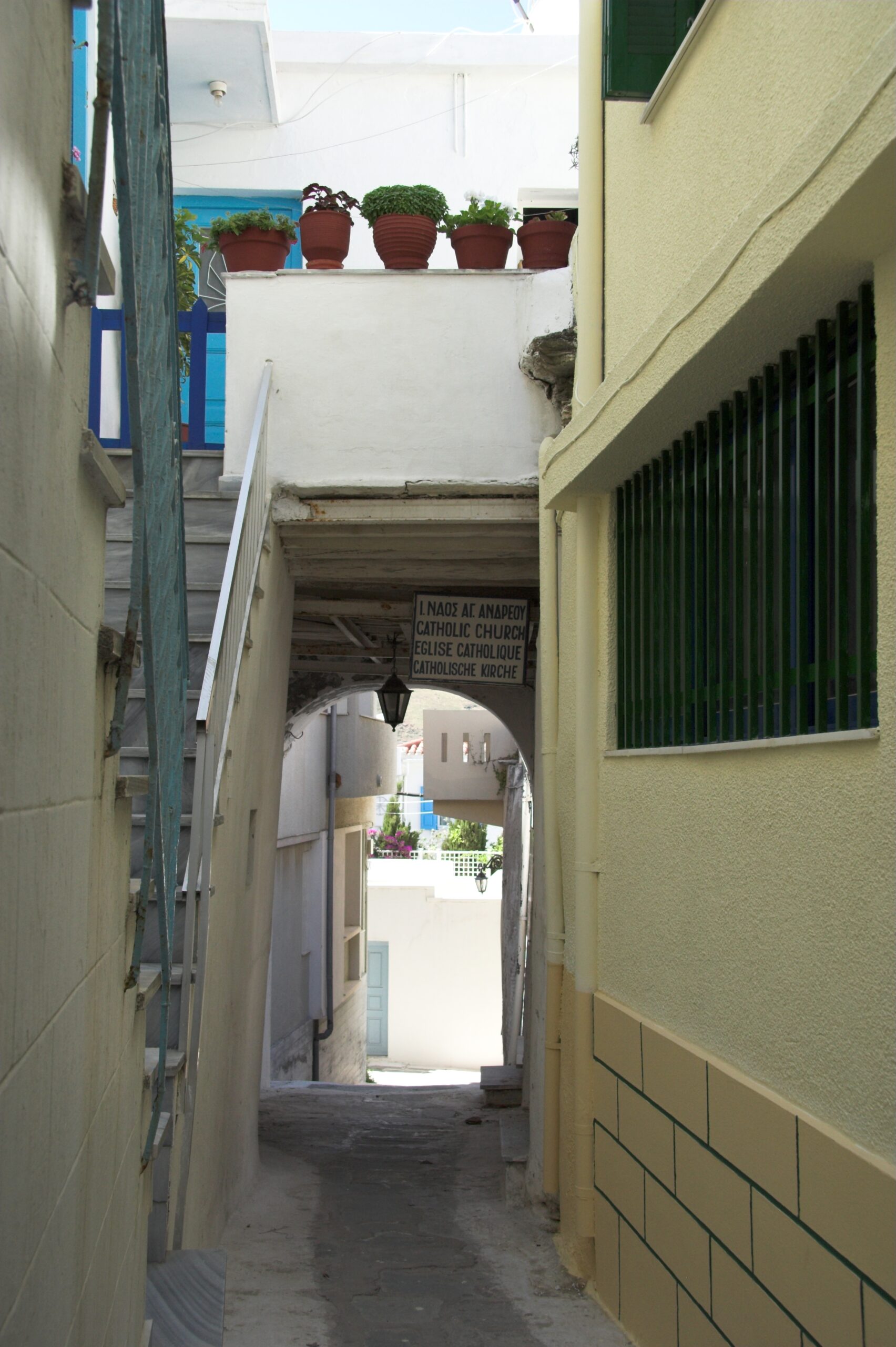 A narrow cobblestone alley in the old town of Andros Chora, Greece