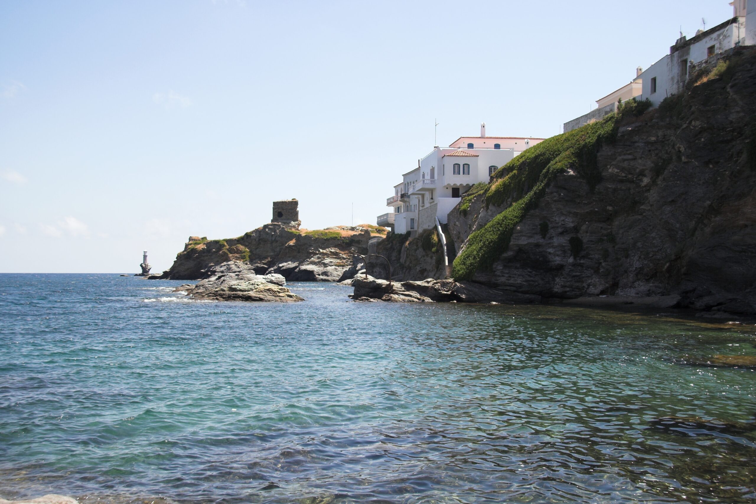 The seafront of Andros Chora with the Venetian Kastro in the background, Cyclades, Greece