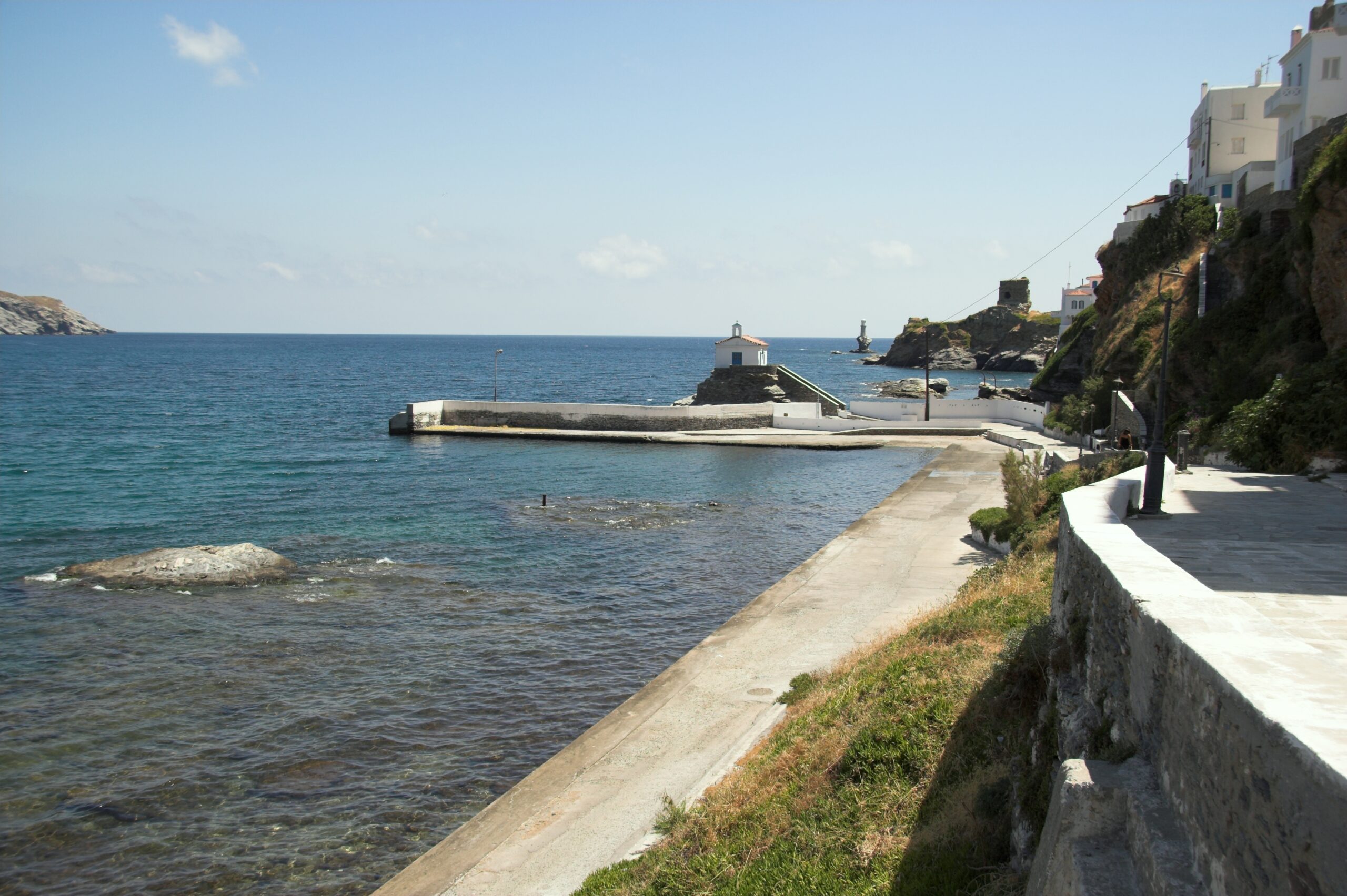 The scenic seafront of Chora, Andros, with traditional architecture facing the Aegean Sea