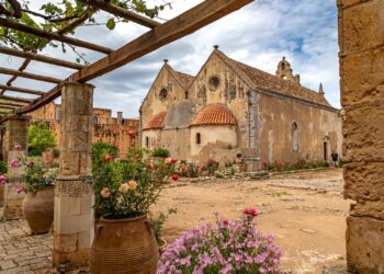 The Renaissance facade and courtyard of Arkadi Monastery surrounded by flowers, southeast of Rethymno