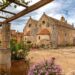 The Renaissance facade and courtyard of Arkadi Monastery surrounded by flowers, southeast of Rethymno