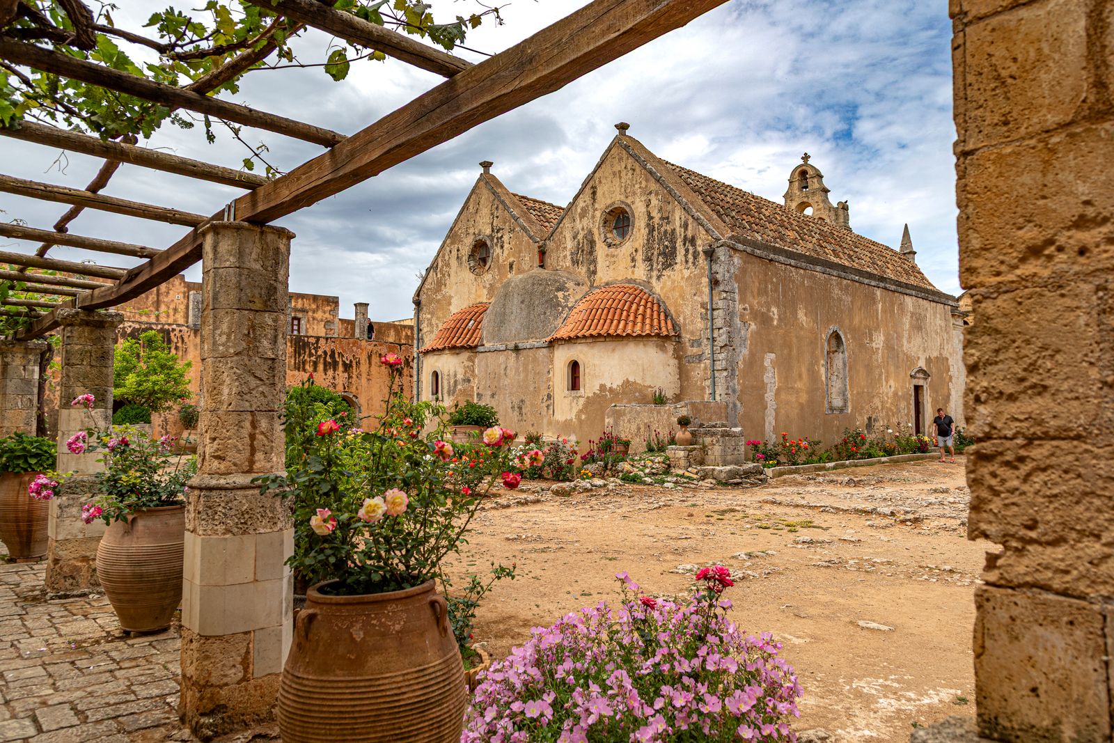 The Renaissance facade and courtyard of Arkadi Monastery surrounded by flowers, southeast of Rethymno