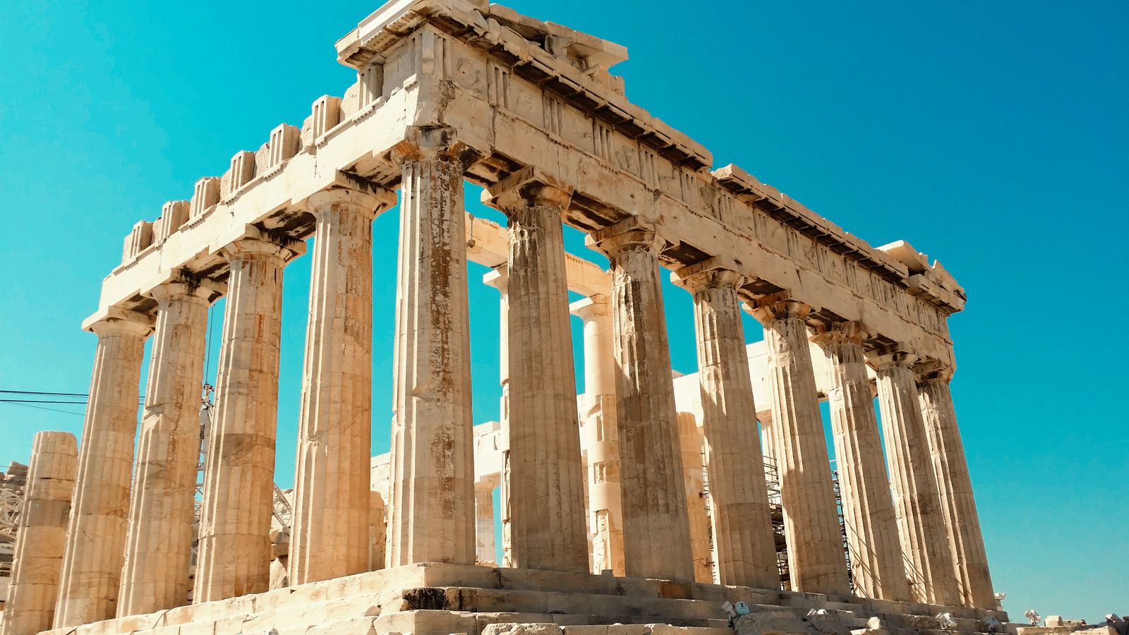 The Parthenon temple on the Acropolis of Athens with its Doric columns against a clear blue sky