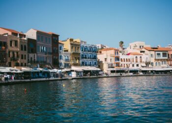 Colourful Venetian-era buildings lining the waterfront of the Old Venetian Harbour in Chania, Crete