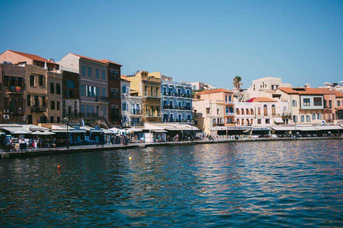 Colourful Venetian-era buildings lining the waterfront of the Old Venetian Harbour in Chania, Crete