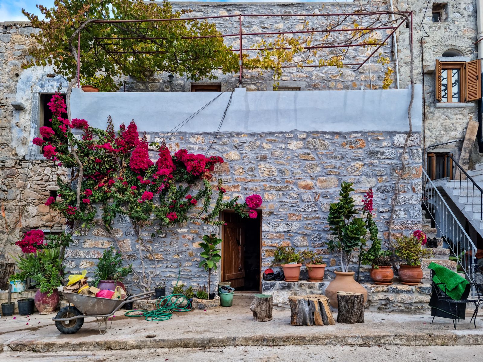 Stone house adorned with potted flowers in the medieval village of Mesta, southern Chios