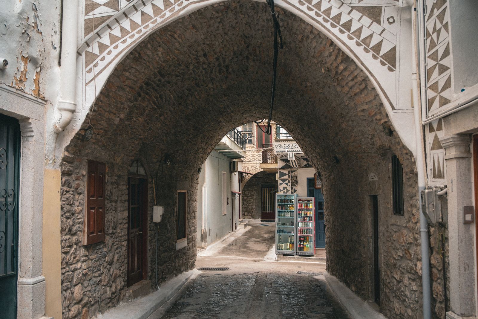 Arched stone passageway leading through a medieval mastic village in southern Chios