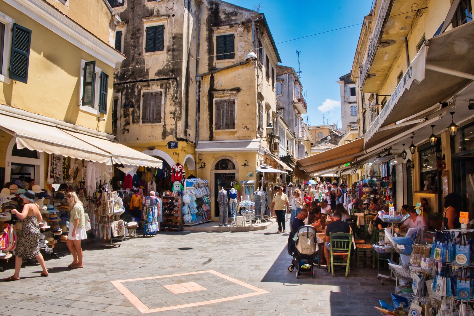Colourful street with traditional shops and cafés in the historic centre of Corfu Town, Greece