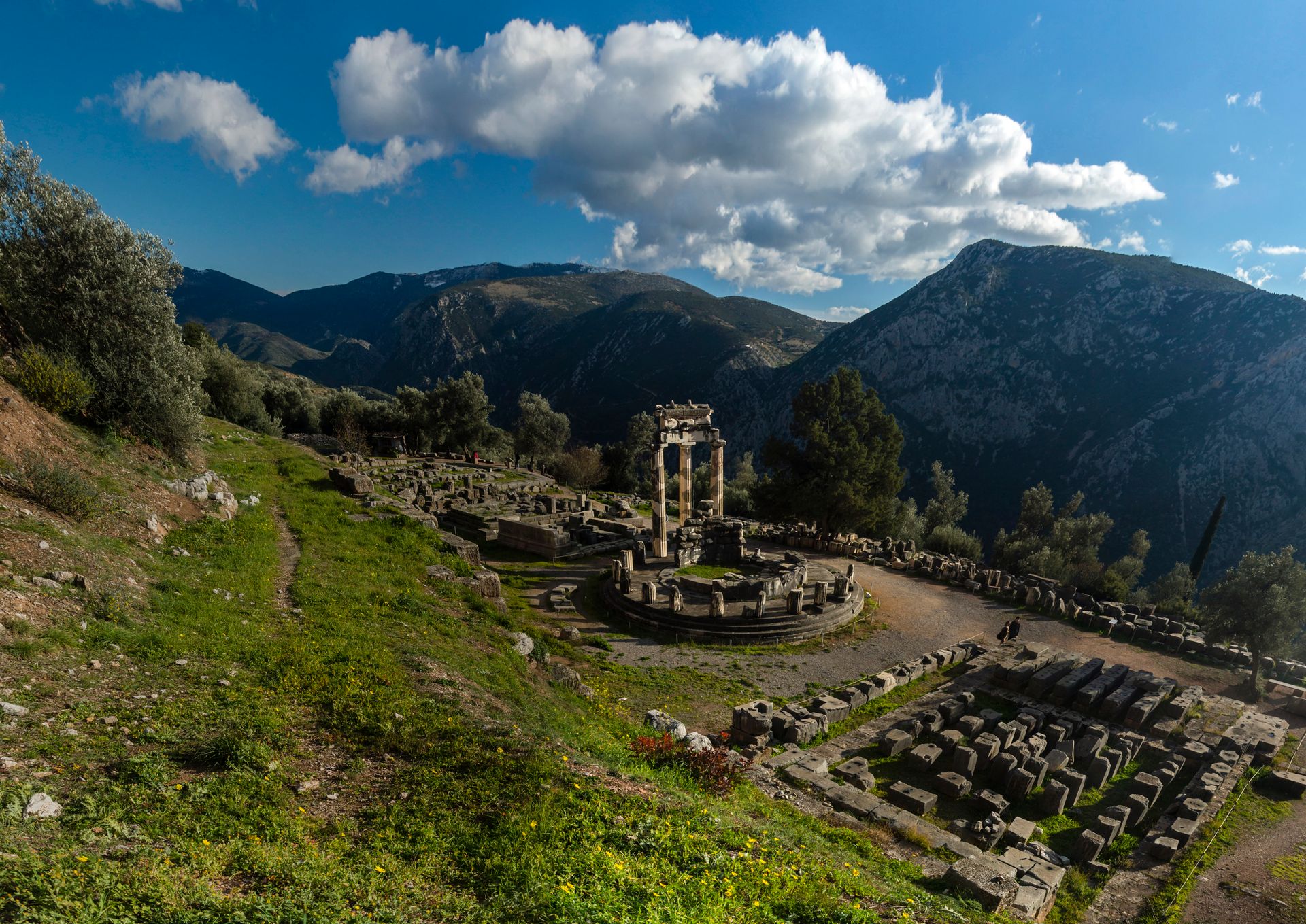 Ancient ruins at Delphi set against the mountain landscape of Central Greece under a blue sky