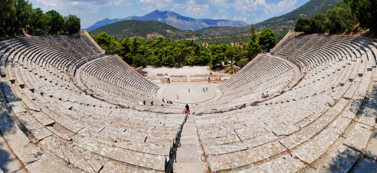 The ancient theatre of Epidaurus seen from above, surrounded by green hills in the Peloponnese