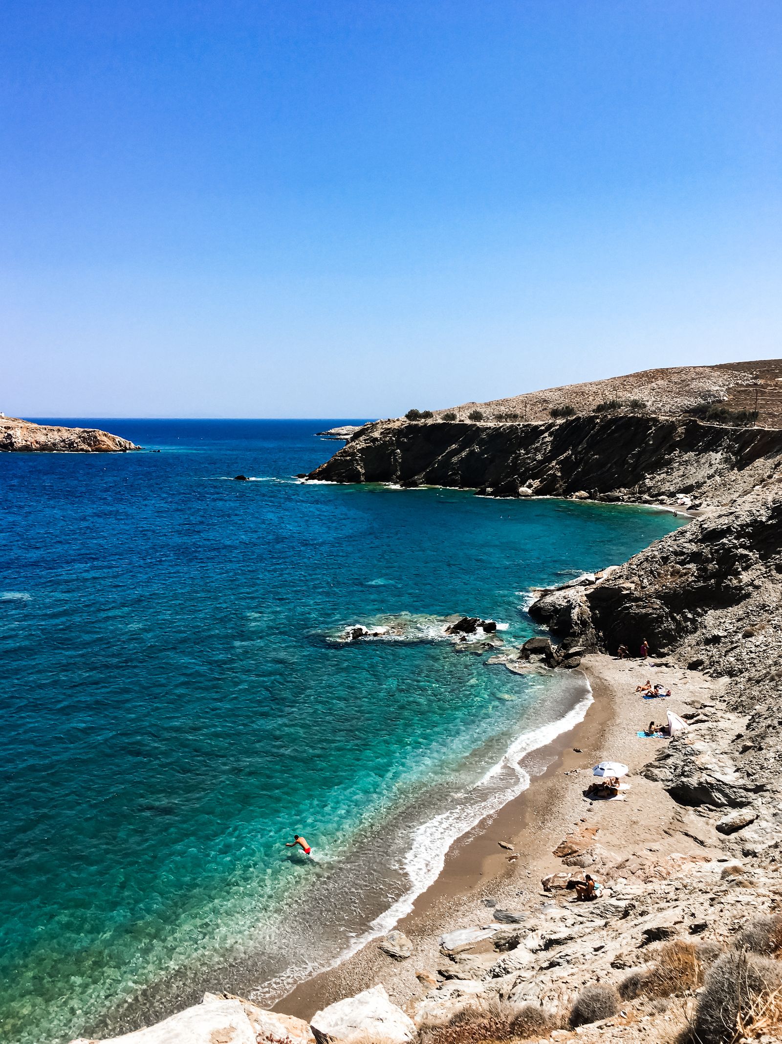 Crystal-clear waters at a sheltered beach on Folegandros island in the Cyclades