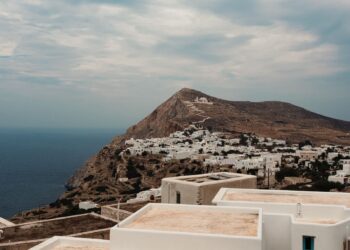 Whitewashed village of Chora perched on a cliff edge above the Aegean Sea on Folegandros island