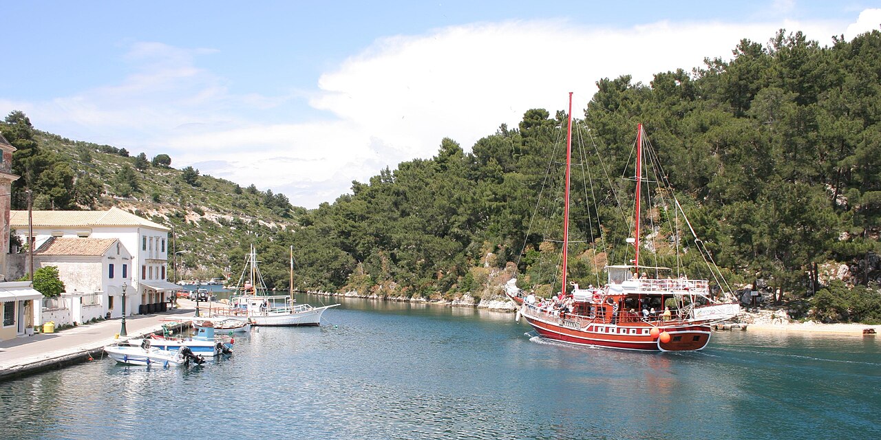 Lakka harbor village in Paxos Greece with white houses and fishing boats