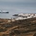 Ferry boat crossing the Aegean Sea near a Greek island village during an island-hopping trip