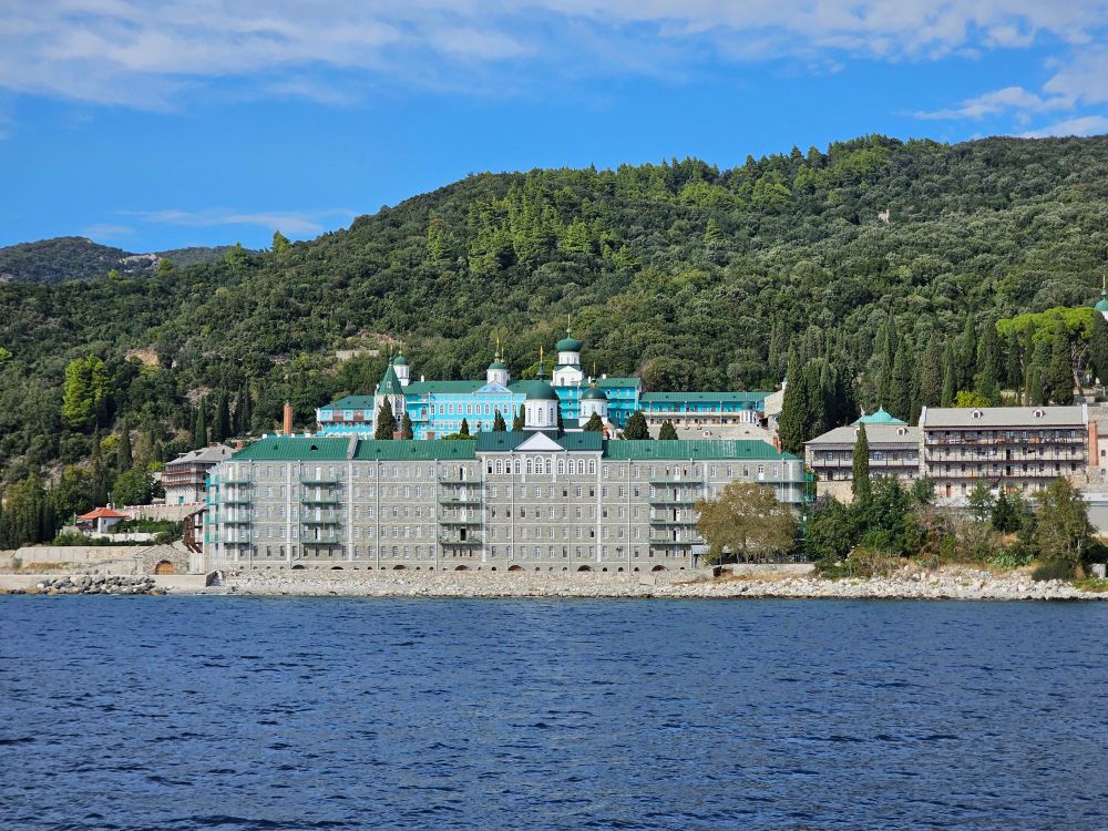 Monastery on Mount Athos peninsula in Halkidiki surrounded by green hills and sea