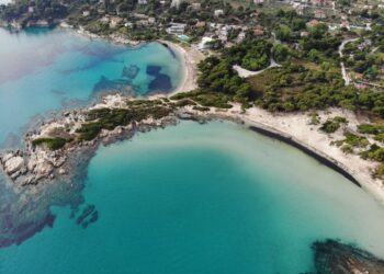 Aerial view of Sithonia coastline in Halkidiki with turquoise water and green hills