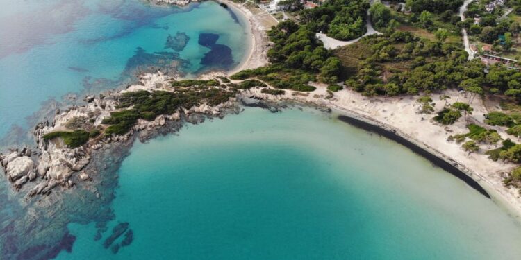 Aerial view of Sithonia coastline in Halkidiki with turquoise water and green hills