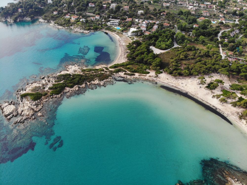 Aerial view of Sithonia coastline in Halkidiki with turquoise water and green hills