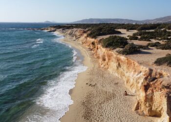 Aerial view of Hawaii Beach in Naxos showing rocky cliffs and clear blue sea