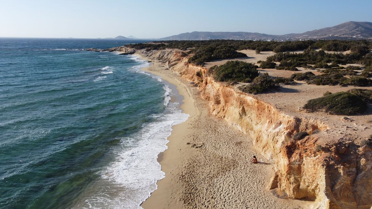 Aerial view of Hawaii Beach in Naxos showing rocky cliffs and clear blue sea