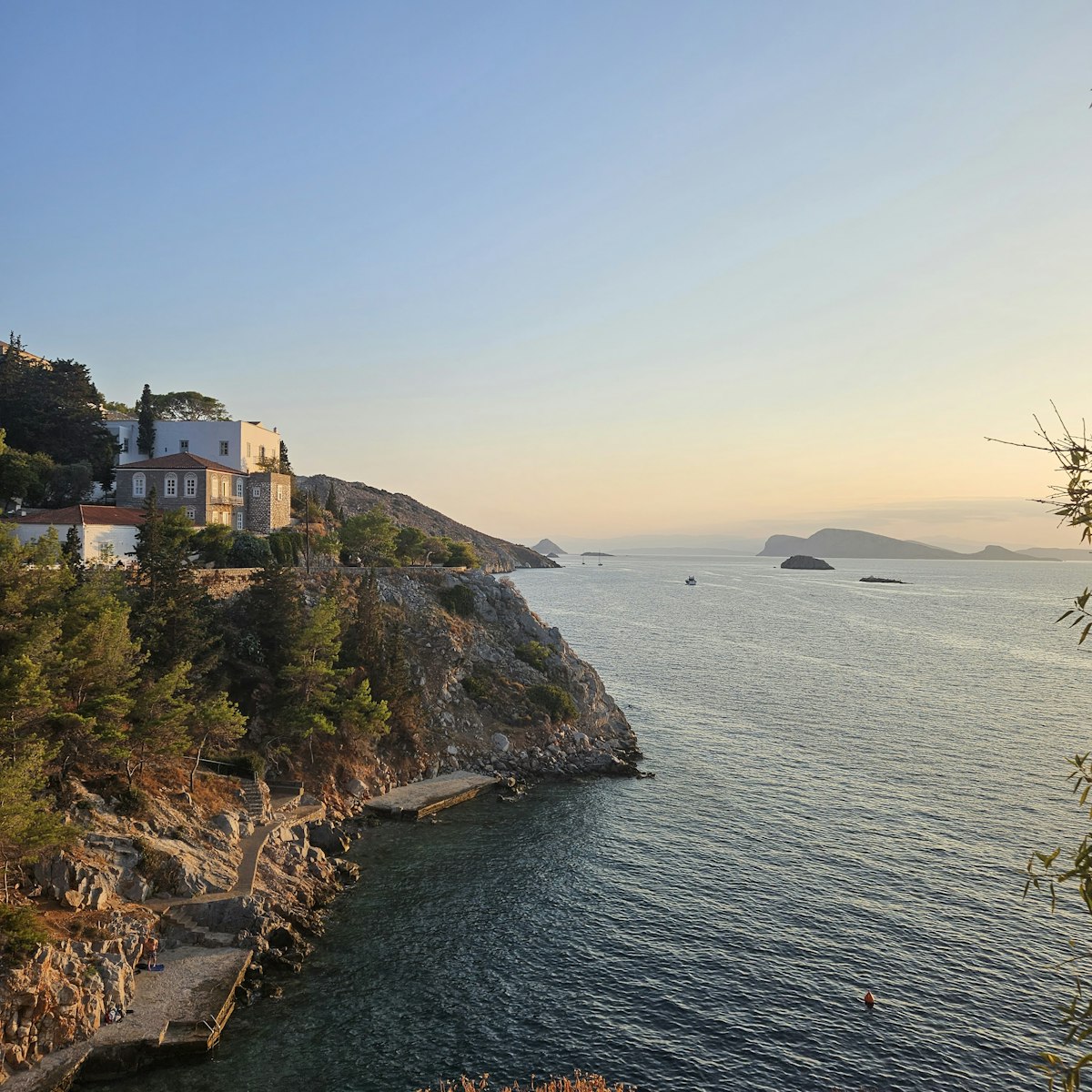 Cliff and coastline view on Hydra Island with the Saronic Gulf in the background