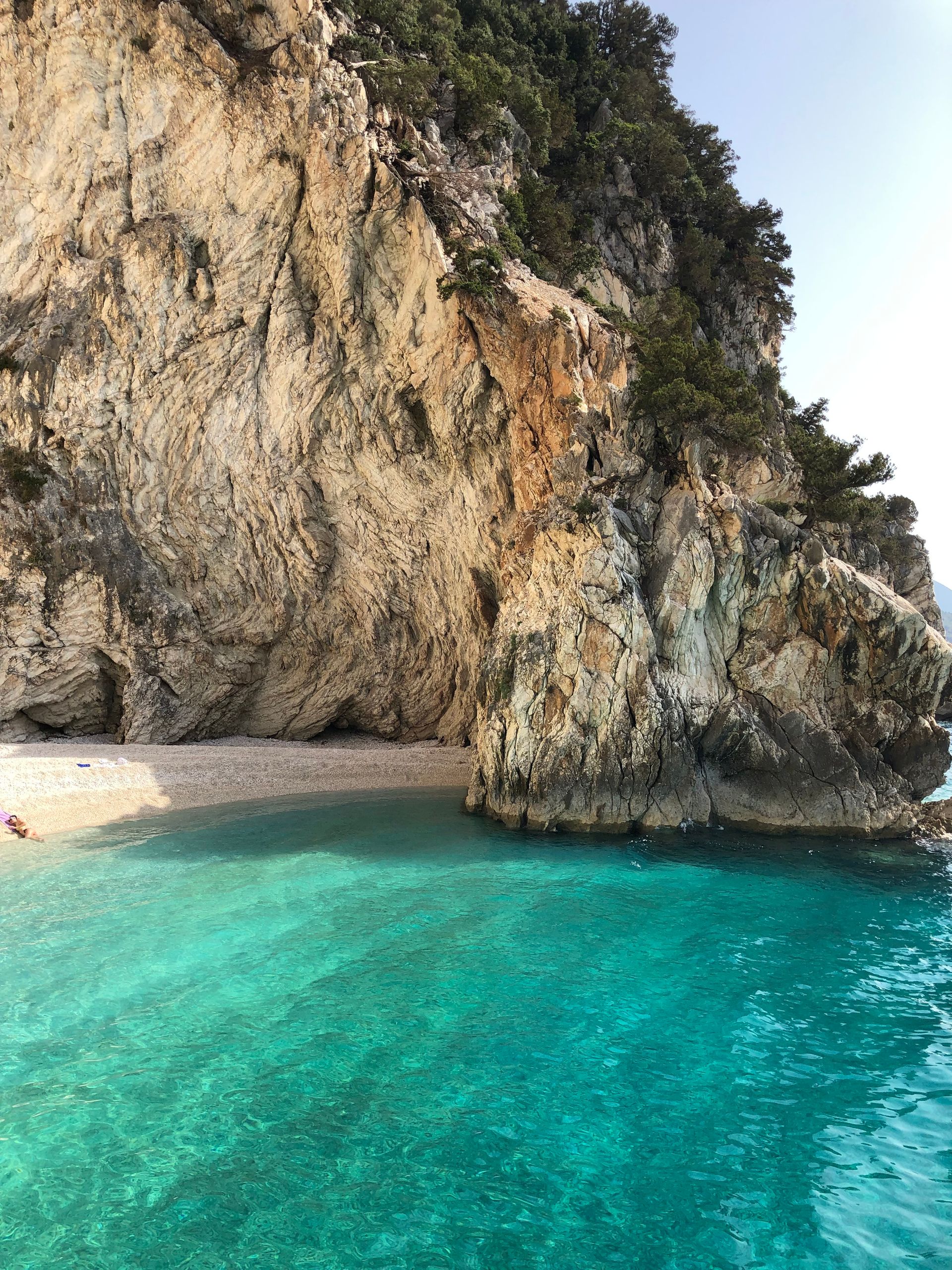 Turquoise waters and rocky cliffs at a secluded beach on Ithaca island Greece