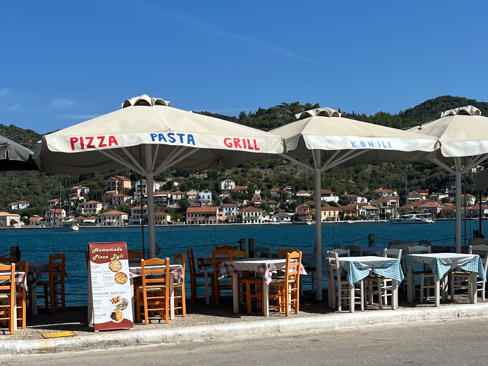 Seaside dining with views over Vathy harbour on Ithaca island Greece