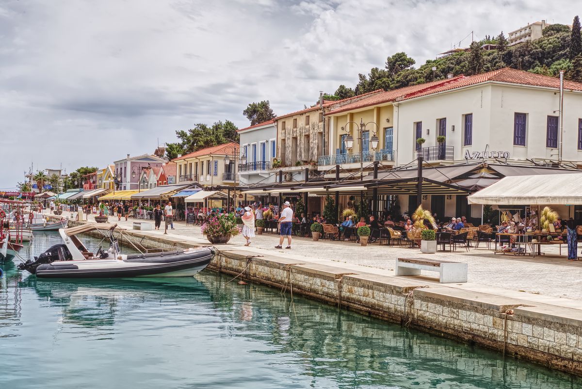 Fiskardo harbour in Kefalonia with moored yachts, colourful waterfront cafes and Venetian-era buildings