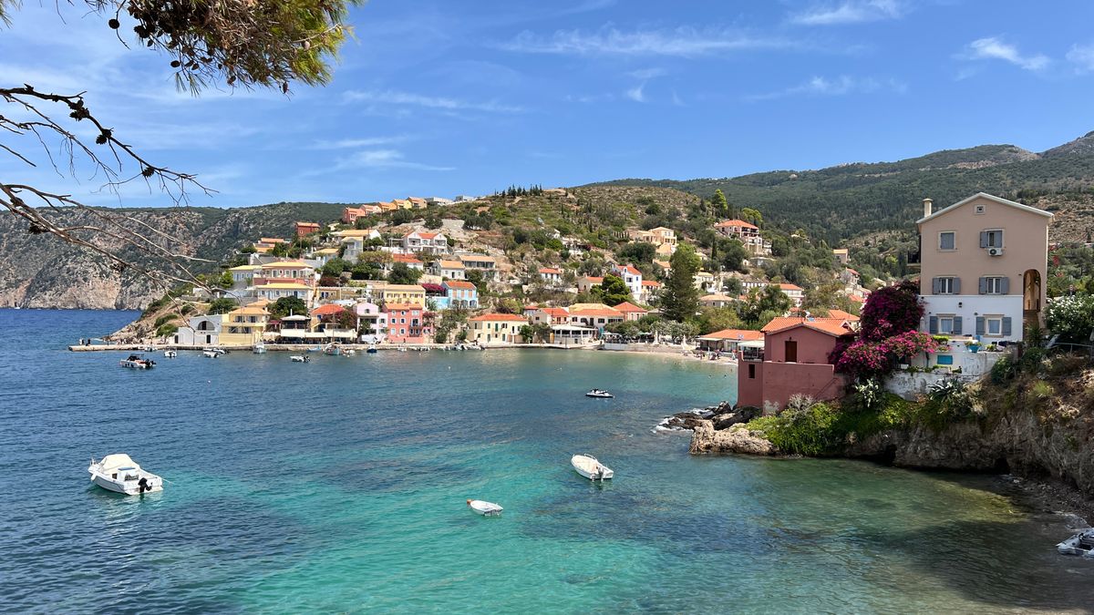 Panoramic view of Assos village with its colourful waterfront houses and turquoise bay in Kefalonia, Greece