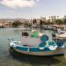 Fishing boats moored in the harbour of Kos Town with waterfront buildings in the background