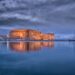 Koules Fortress reflected in calm waters at Heraklion harbour during twilight