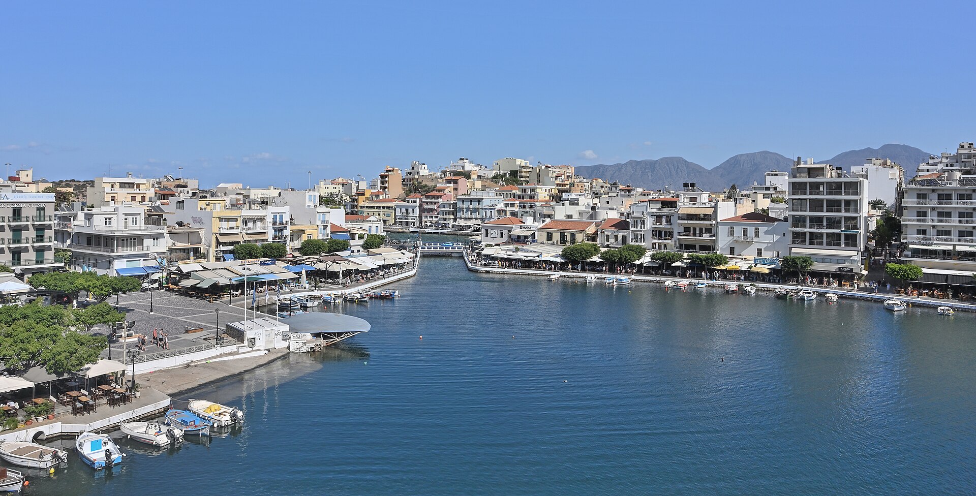 Lake Voulismeni surrounded by cafes and houses in Agios Nikolaos, Crete.