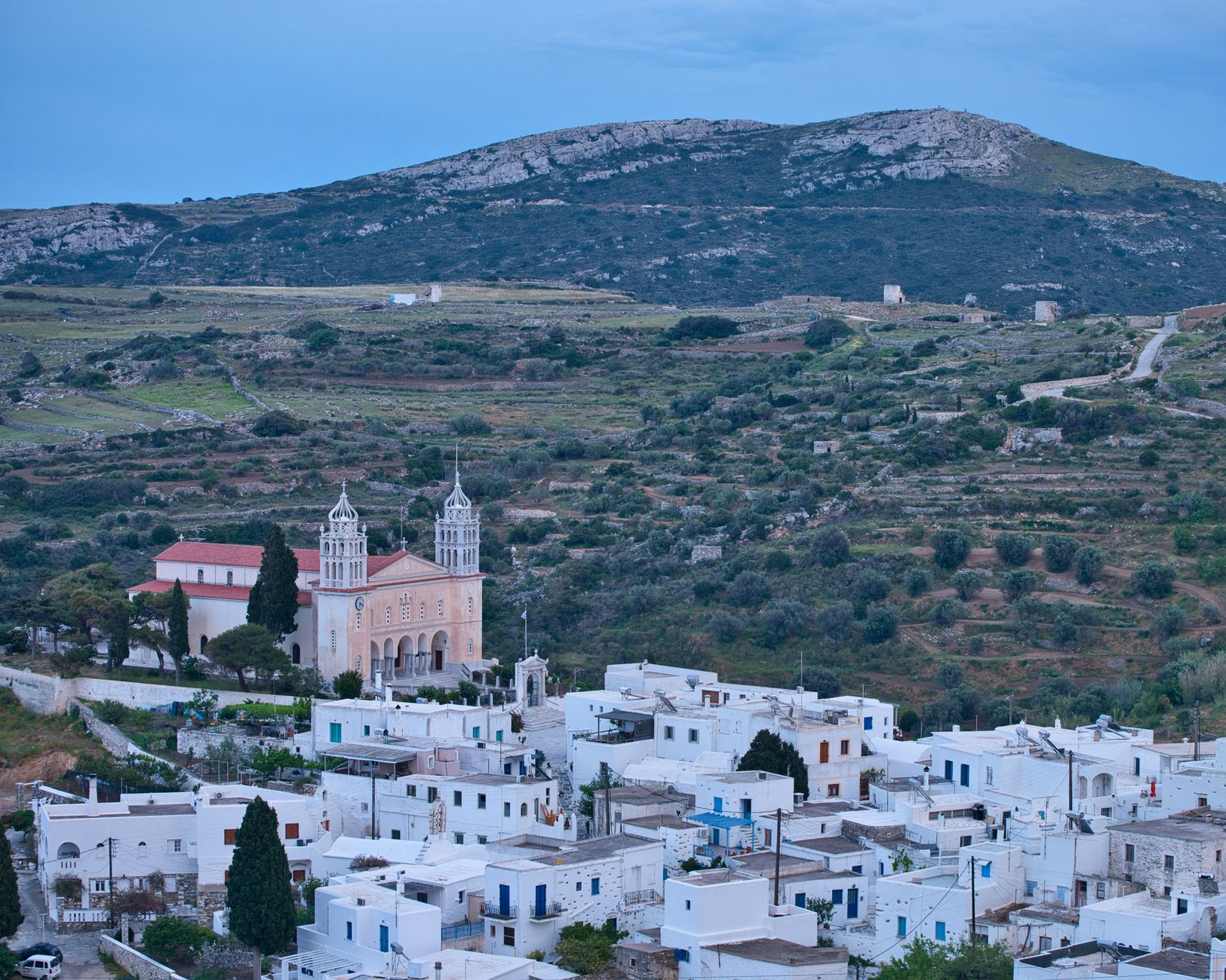 The marble Church of Agia Triada and the rooftops of Lefkes village, Paros