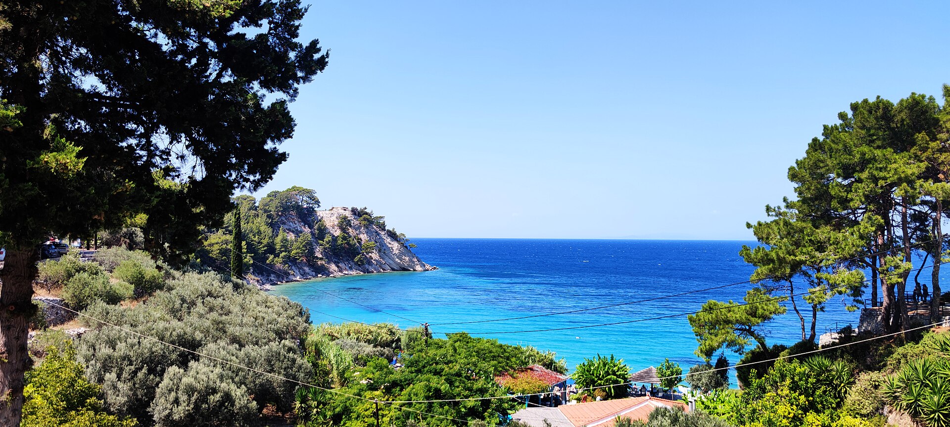 Turquoise water and pine-covered coast at Lemonakia Beach, Samos.