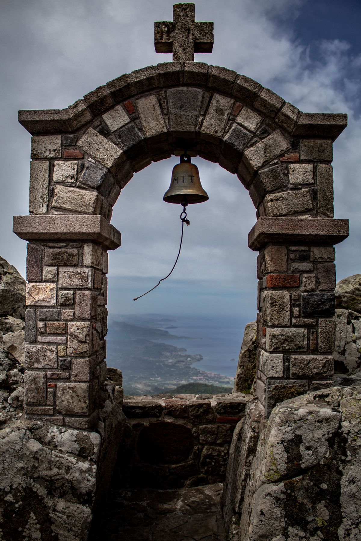 Stone archway in the medieval village of Mythimna Lesvos with narrow cobblestone street