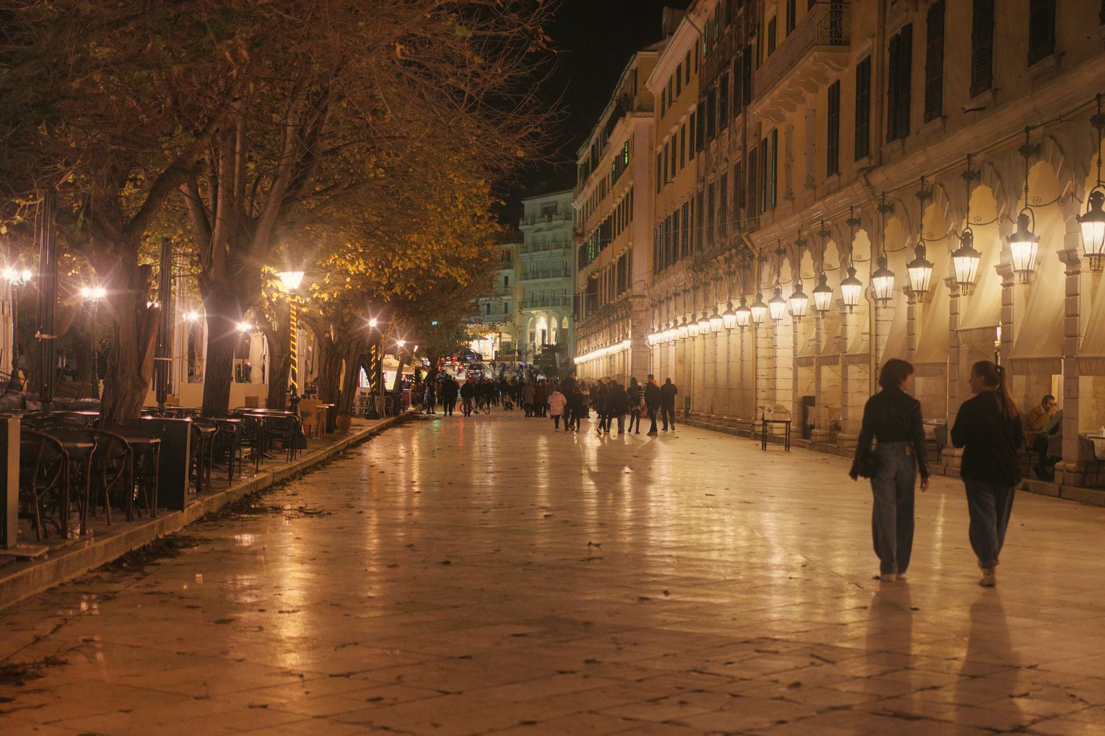 The Liston promenade in Corfu Town illuminated at night with pedestrians strolling beneath its arcades