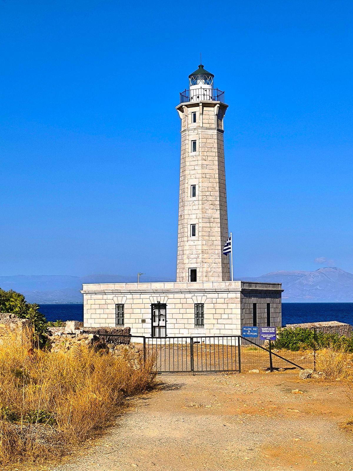 Historic stone lighthouse at Cape Tenaro, the southernmost point of mainland Greece, under a clear blue sky