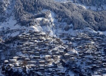 Snowy Metsovo town and surrounding mountain slopes