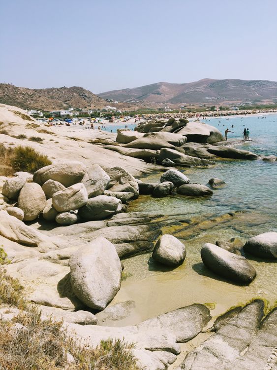 Rocky coastline and clear waters at Mikri Vigla beach in Naxos, popular for windsurfing